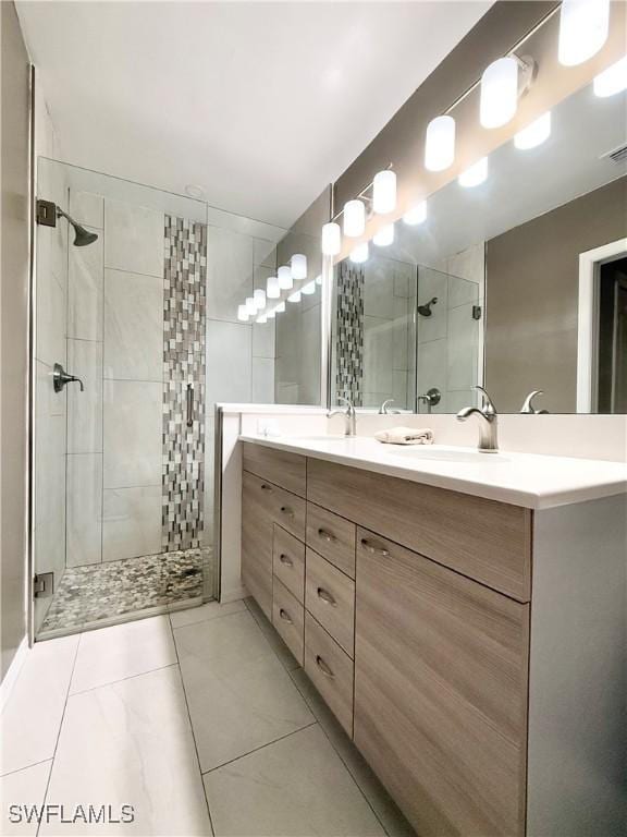 bathroom featuring vanity, tile patterned flooring, and a shower with door