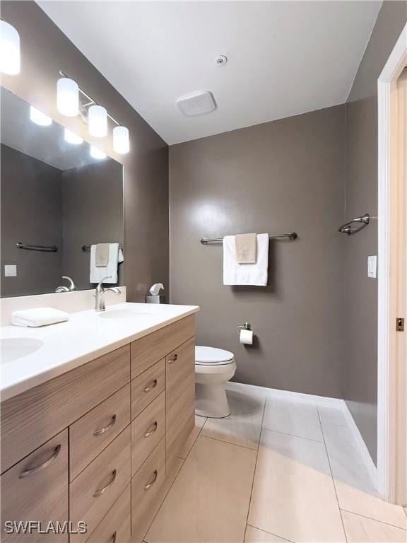 bathroom featuring vanity, toilet, and tile patterned flooring