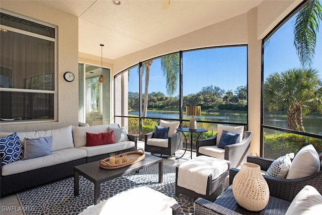 sunroom / solarium featuring a water view and lofted ceiling