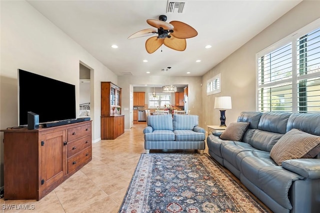 living room featuring ceiling fan and light tile patterned floors