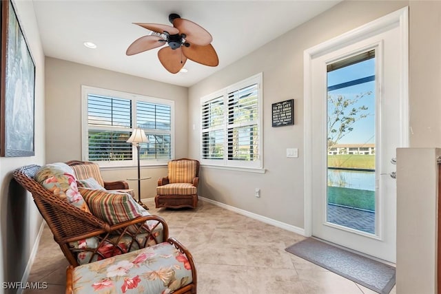 sitting room with light tile patterned flooring and ceiling fan