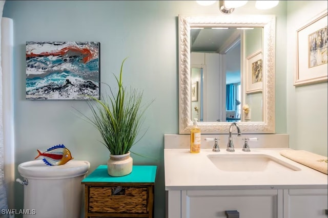 bathroom featuring vanity and toilet