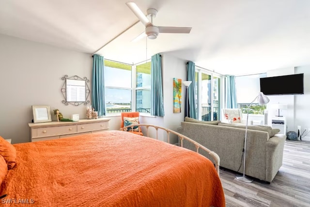 bedroom with multiple windows, ceiling fan, and light hardwood / wood-style flooring