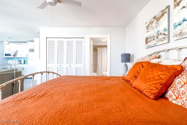 bedroom with white refrigerator, ceiling fan, and a closet