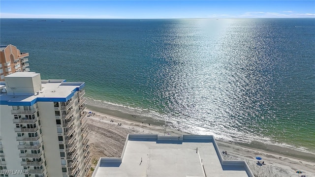 bird's eye view with a water view and a beach view