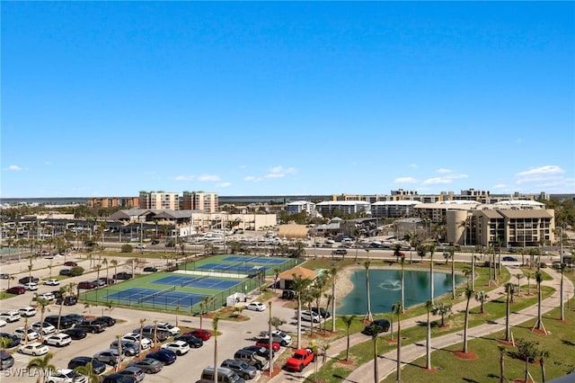 birds eye view of property with a water view and a city view