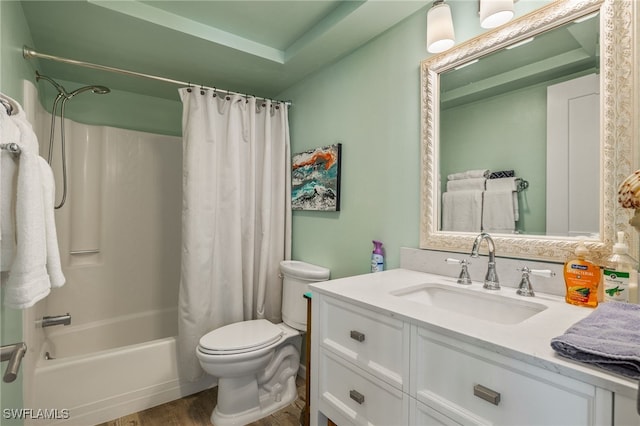 full bathroom featuring wood finished floors, shower / bath combo, vanity, and toilet