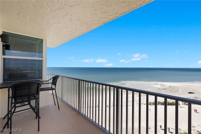 balcony with a beach view and a water view