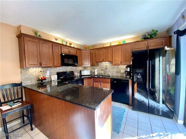 kitchen featuring sink, black appliances, light tile patterned flooring, decorative backsplash, and kitchen peninsula