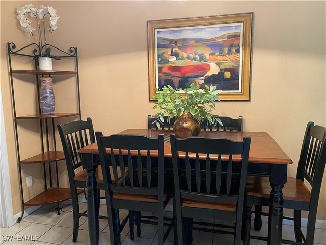 dining space featuring tile patterned flooring