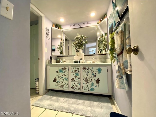 bathroom with tile patterned floors, vanity, and backsplash