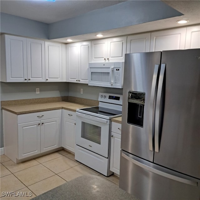 kitchen featuring light tile patterned floors, recessed lighting, white appliances, and white cabinetry