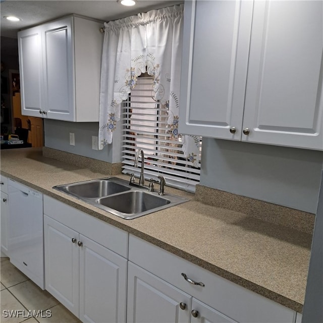 kitchen with light tile patterned flooring, a sink, dishwasher, white cabinetry, and recessed lighting