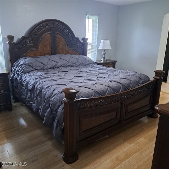 bedroom with hardwood / wood-style floors