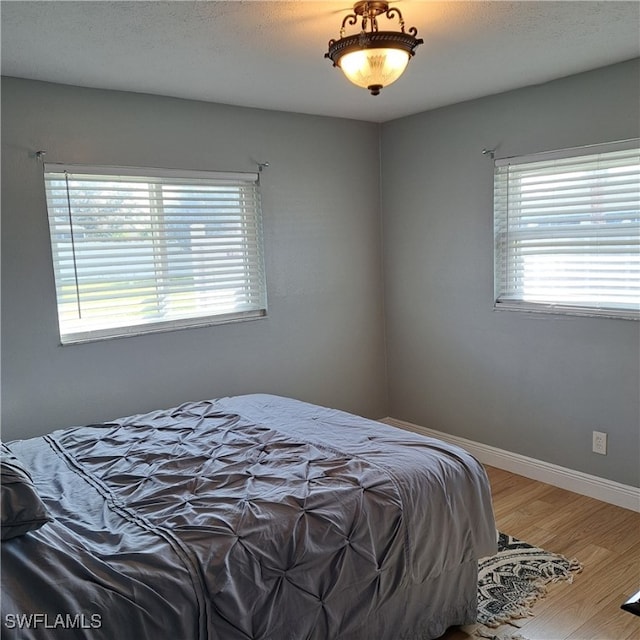 bedroom featuring wood-type flooring and a textured ceiling