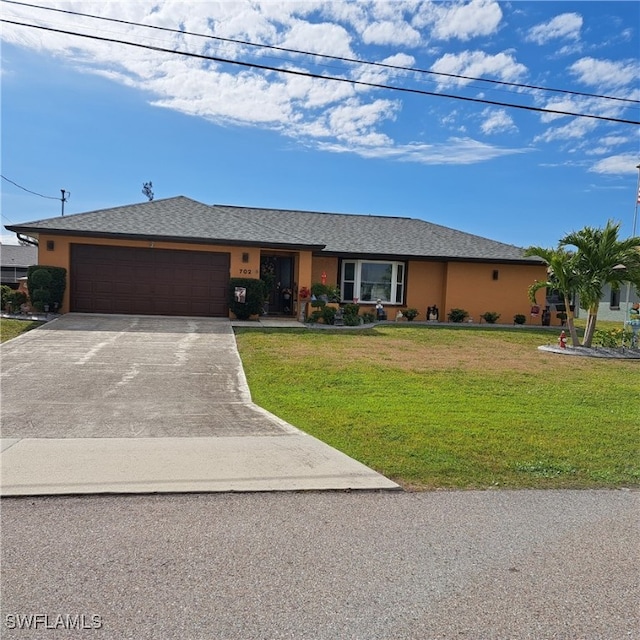 ranch-style house with a garage and a front lawn