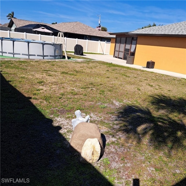 view of yard with a fenced in pool and a patio area