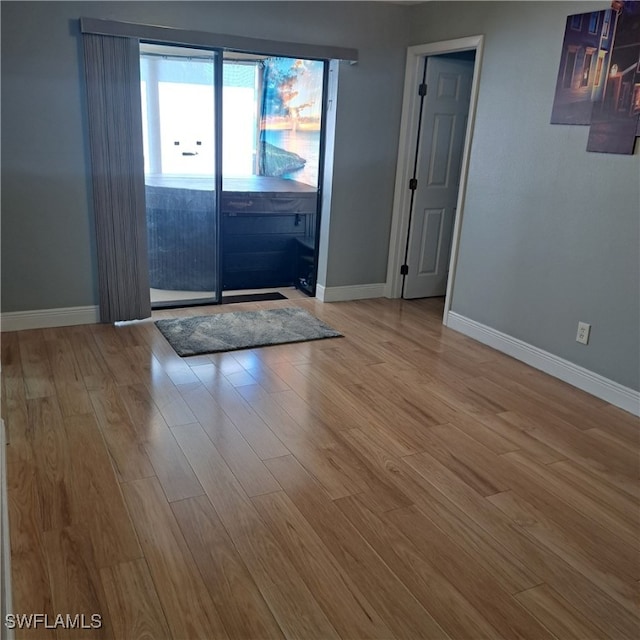 entryway featuring baseboards and wood finished floors
