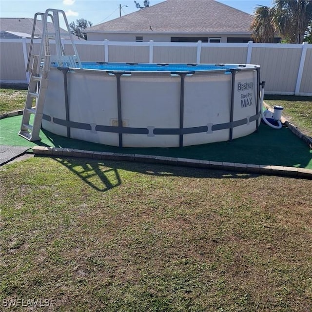 view of yard with a fenced in pool