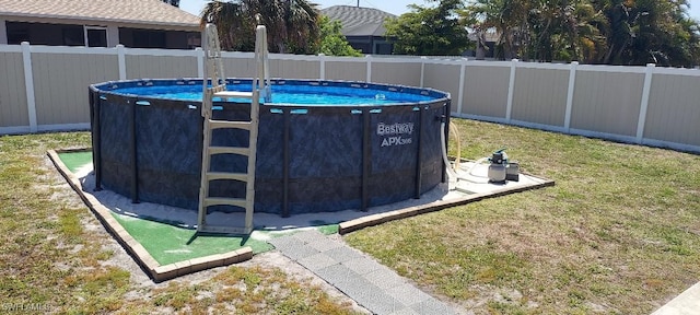 exterior space with a lawn, a fenced in pool, and a fenced backyard