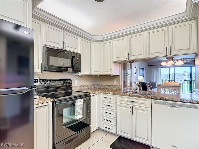 kitchen with sink, light stone counters, light tile patterned floors, kitchen peninsula, and black appliances