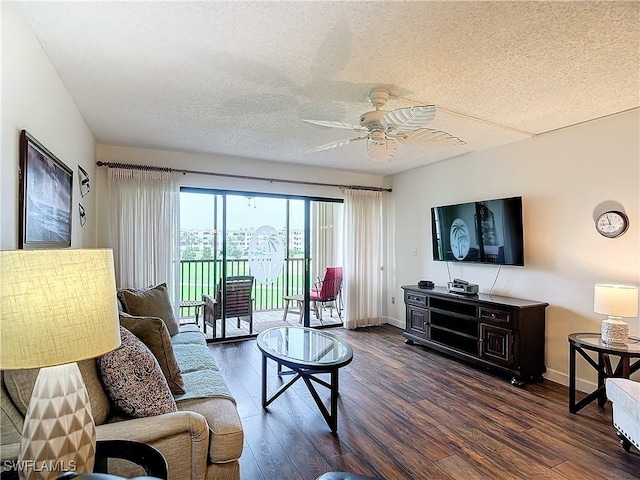 living room with ceiling fan, a textured ceiling, and dark hardwood / wood-style flooring