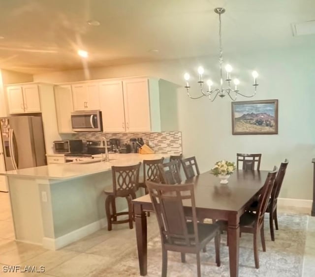 dining area featuring sink and a notable chandelier