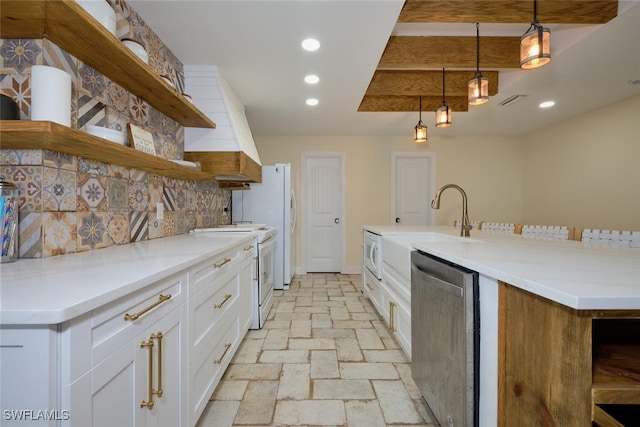 kitchen featuring white electric stove, dishwasher, white cabinets, hanging light fixtures, and a center island with sink