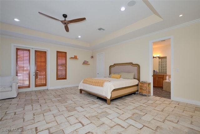 bedroom with connected bathroom, ornamental molding, a raised ceiling, and ceiling fan