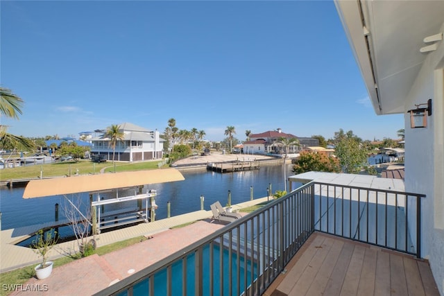 balcony featuring a water view and a boat dock