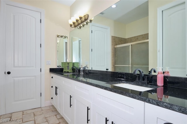 bathroom with an enclosed shower and vanity