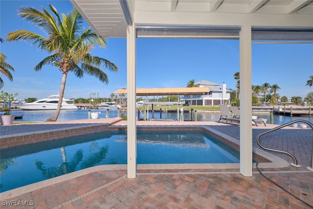 view of swimming pool featuring a water view and a patio area