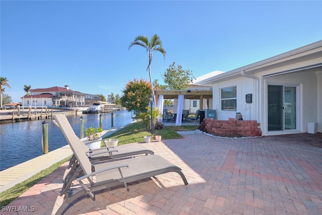 view of patio with a water view and a boat dock