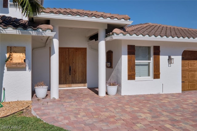 view of exterior entry with a garage