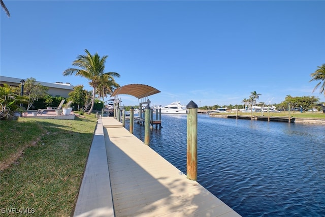 dock area with a water view and a yard