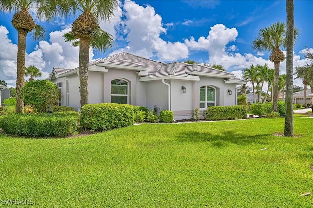 mediterranean / spanish house with a front yard