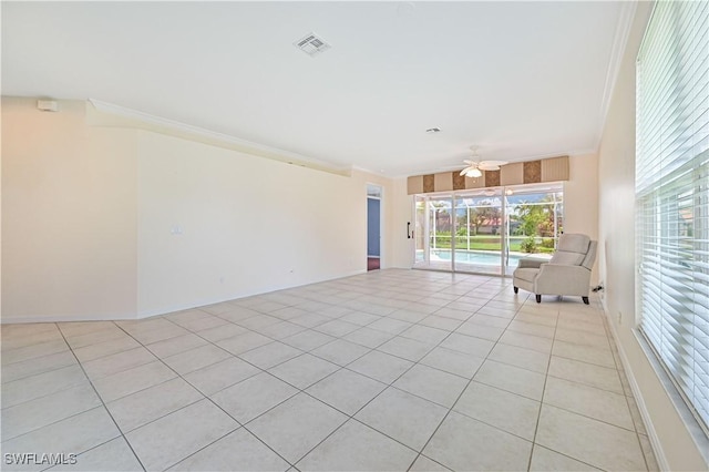 interior space featuring ornamental molding, light tile patterned flooring, and ceiling fan