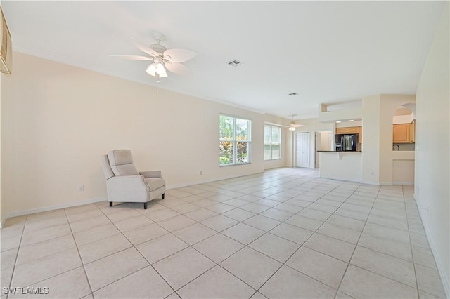 unfurnished living room featuring light tile patterned flooring and ceiling fan