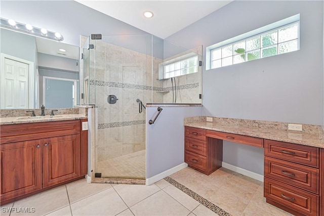 bathroom with tile patterned floors, vanity, and a shower with door