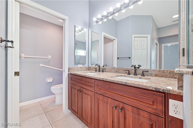 bathroom featuring tile patterned flooring, vanity, and toilet