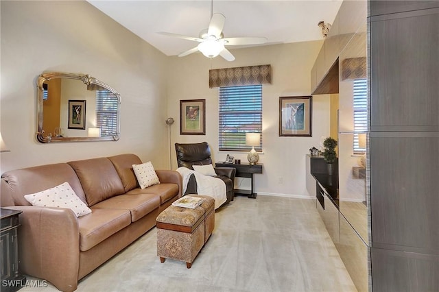 carpeted living room with ceiling fan and plenty of natural light