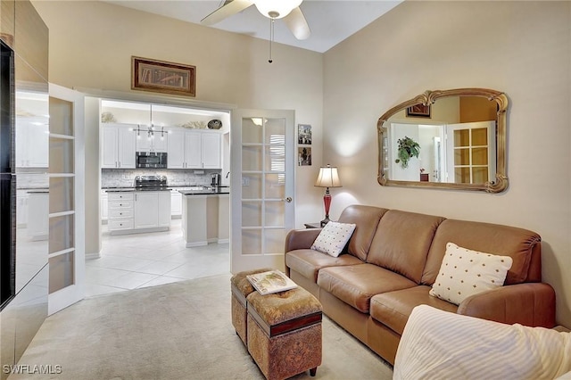 living room with light tile patterned floors and ceiling fan