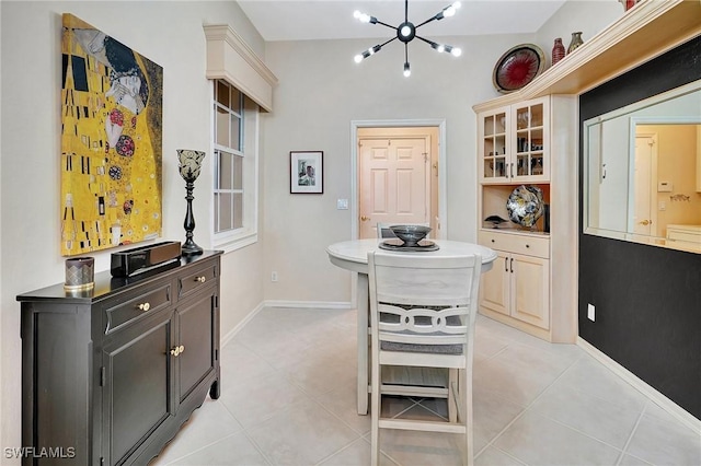 dining area with a chandelier and light tile patterned flooring