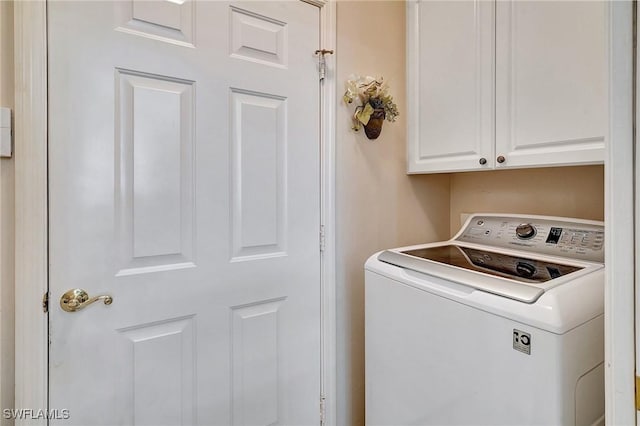 laundry room featuring washer / clothes dryer and cabinets