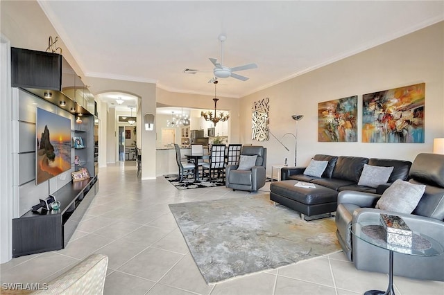 living room with light tile patterned floors, ceiling fan with notable chandelier, and ornamental molding