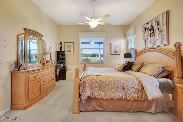 bedroom with multiple windows, light carpet, and ceiling fan