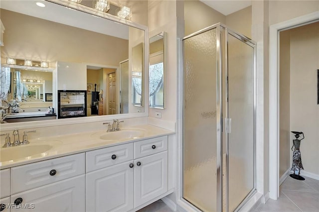 bathroom with vanity, a shower with shower door, and tile patterned floors