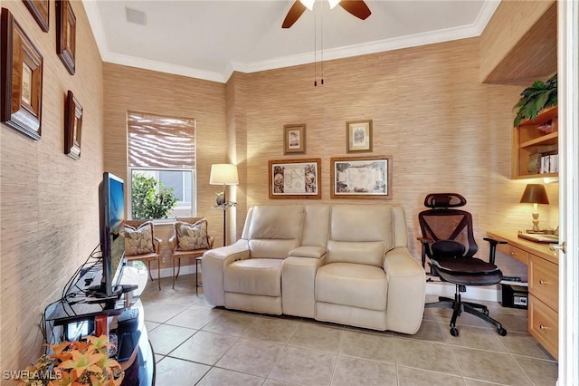 tiled living room with crown molding, ceiling fan, and built in desk