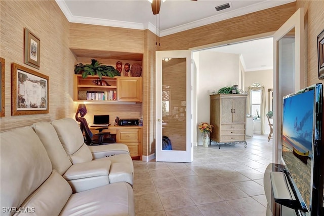 tiled living room with ornamental molding, french doors, and ceiling fan