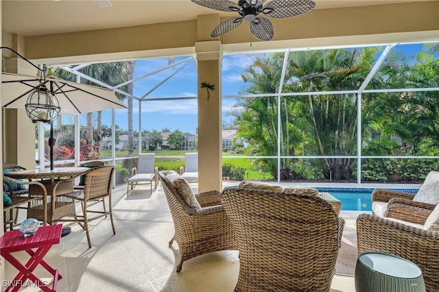 view of patio / terrace with ceiling fan and glass enclosure